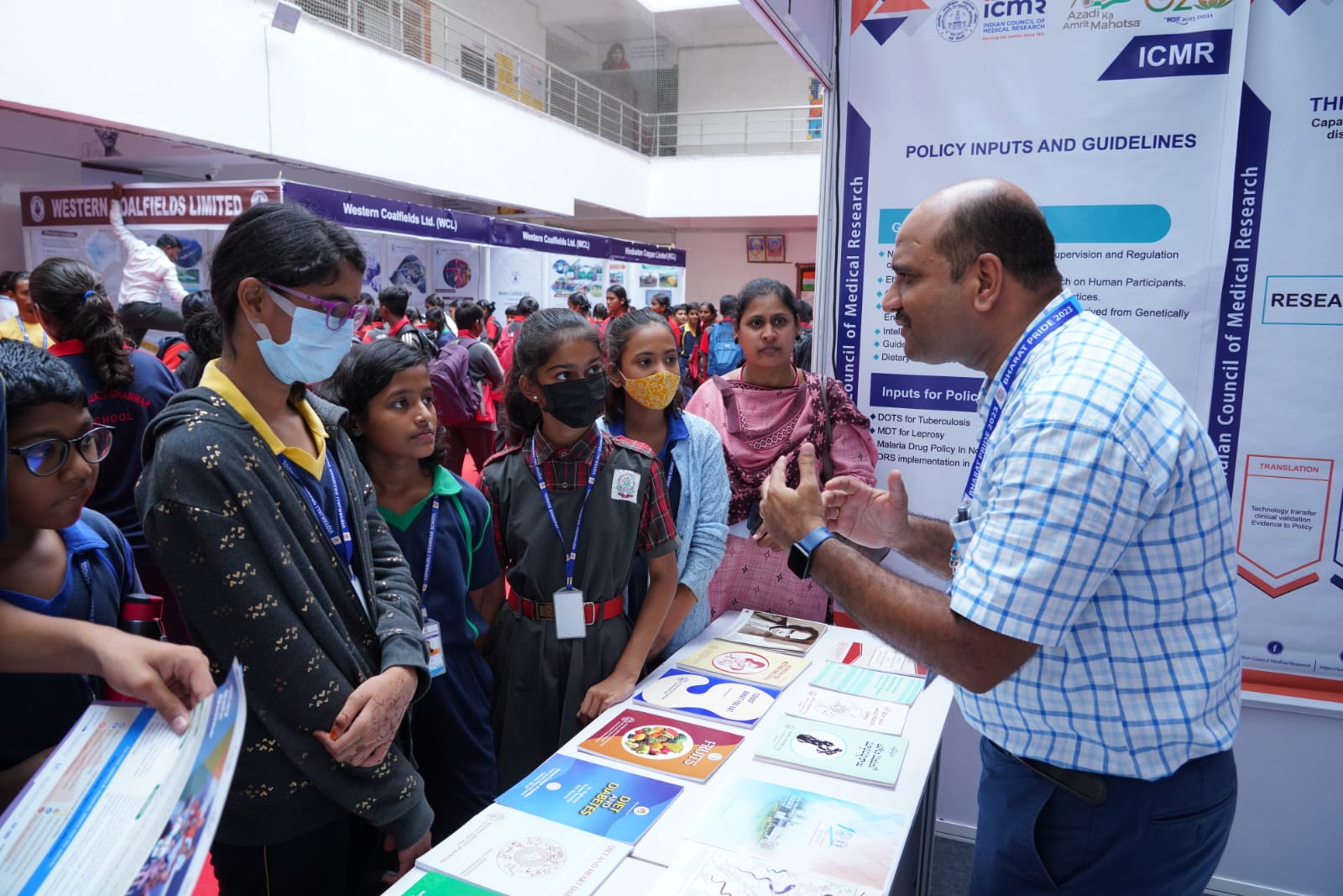 Students learning about medical research at a Bharat Pride exhibition