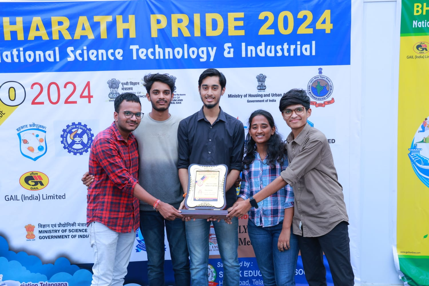 Student participants holding an award at Bharat Pride 2024